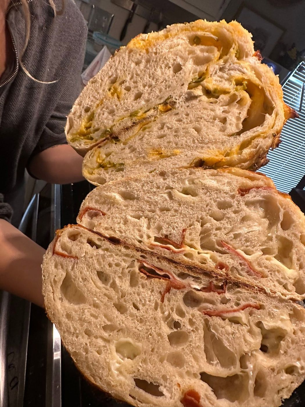 A stuffed sourdough loaf sliced open